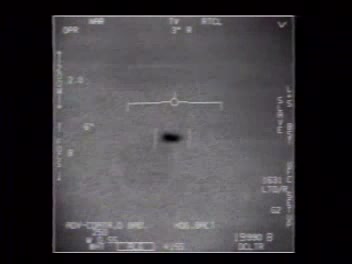 FLIR1 ATFLIR still showing the Tic Tac object as a dark capsule silhouette centered in the infrared crosshairs, with HUD telemetry overlaid